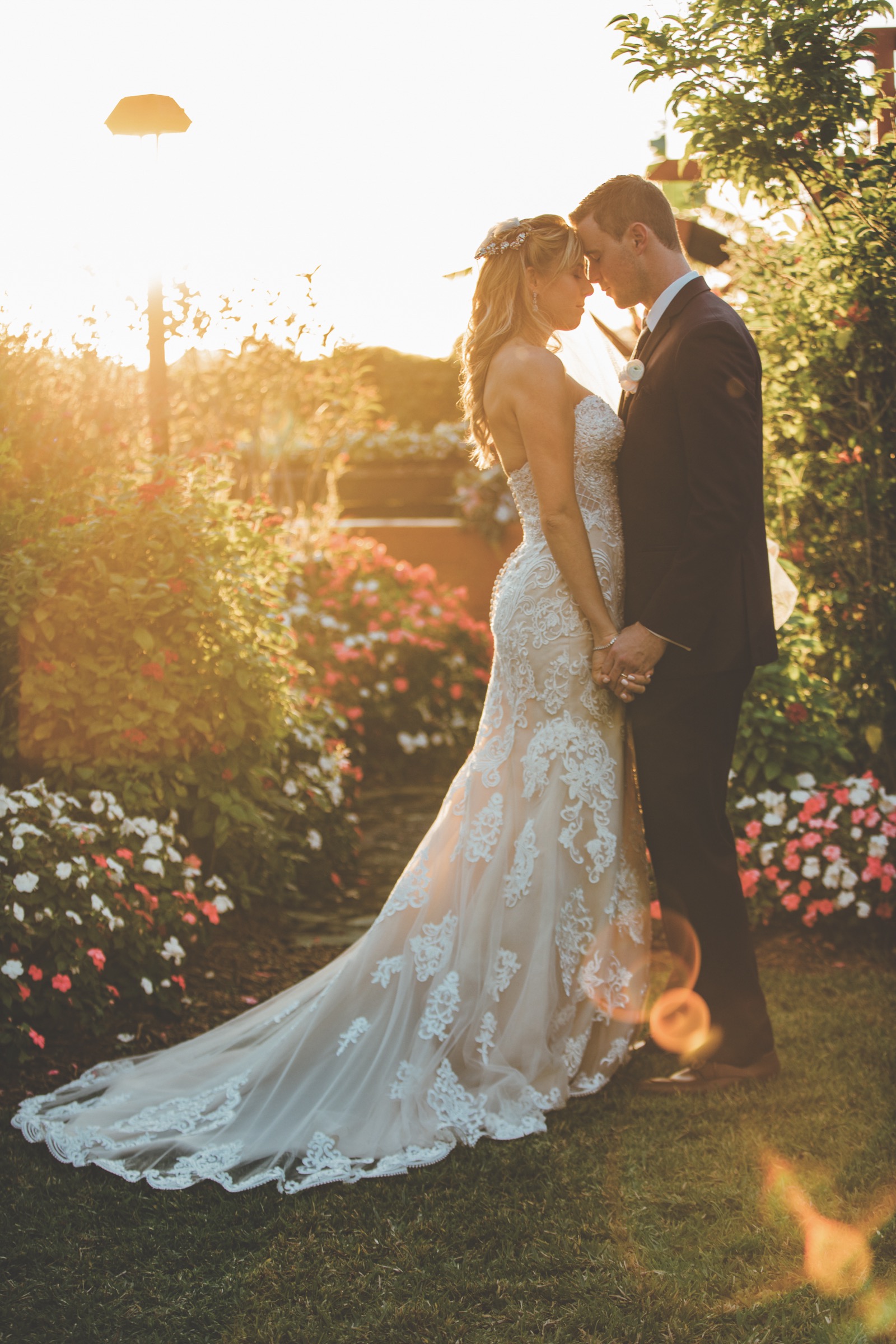 Newlyweds sharing a quiet golden-hour moment in the gardens at The Arbor Estate