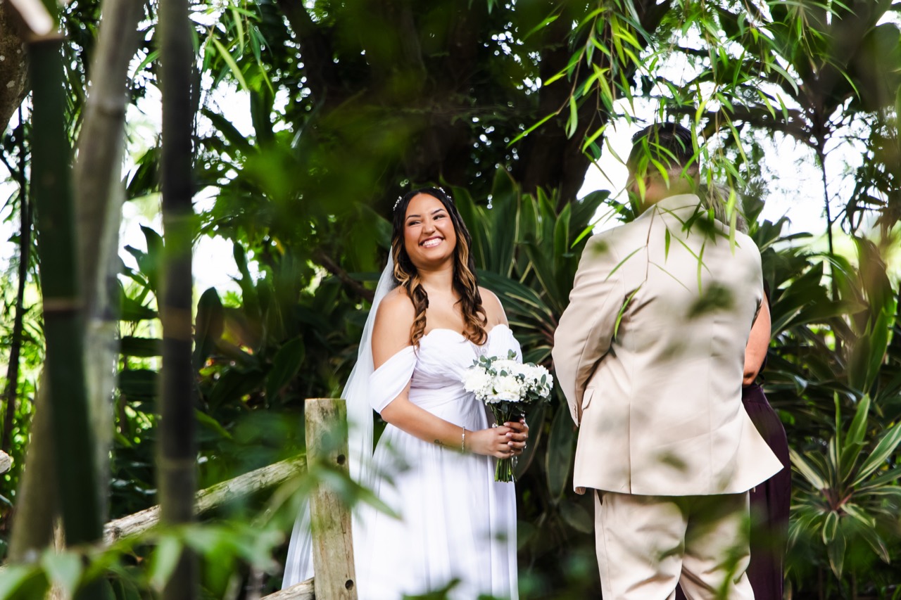 Kaila smiling at Vincent during their garden ceremony